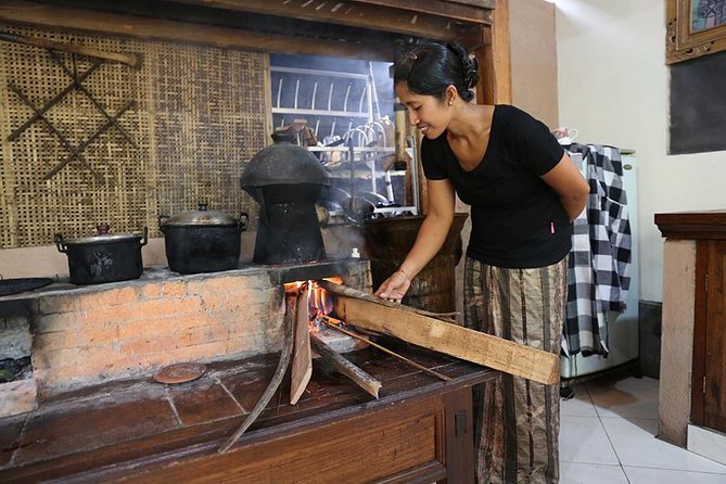 PRIVATE Balinese Cooking Class in Ubud with Dewa with Transfers - Cooking over a traditional wood-fired stove